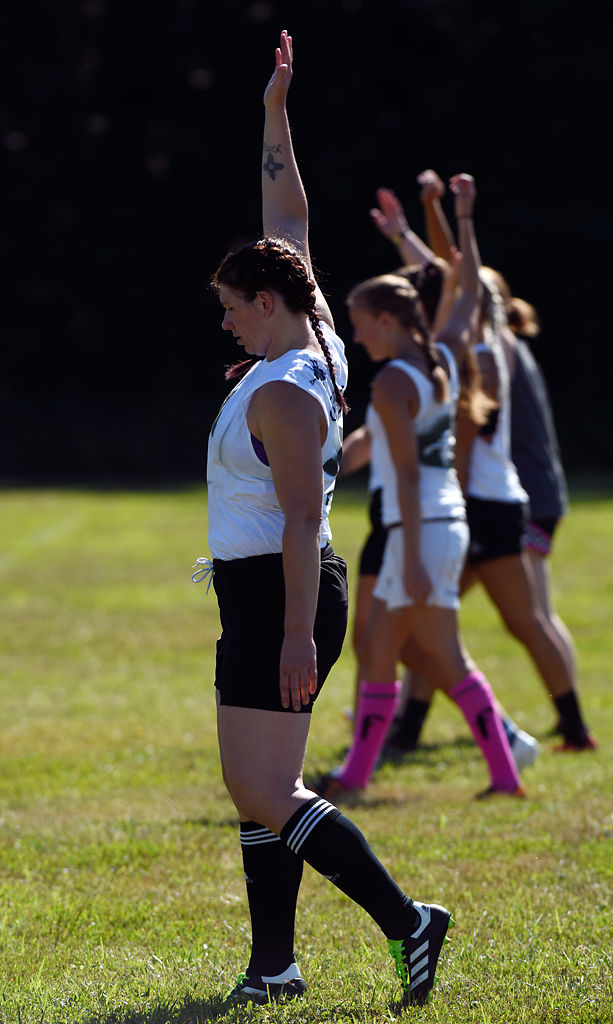 Elana Wilson warms up with windmill exercises